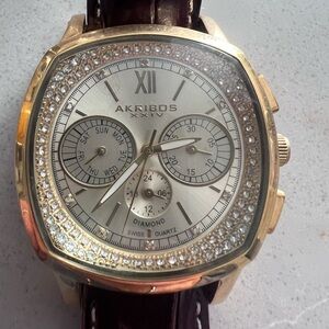 Gold Akribos XXIV watch with diamond Swiss quartz